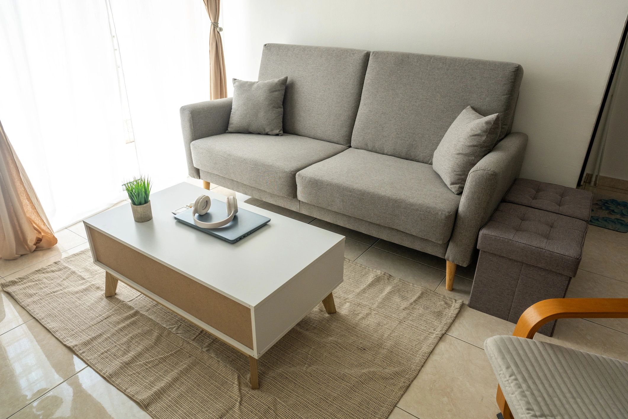 Minimal living room with sofa and armchair in a calm neutral palette